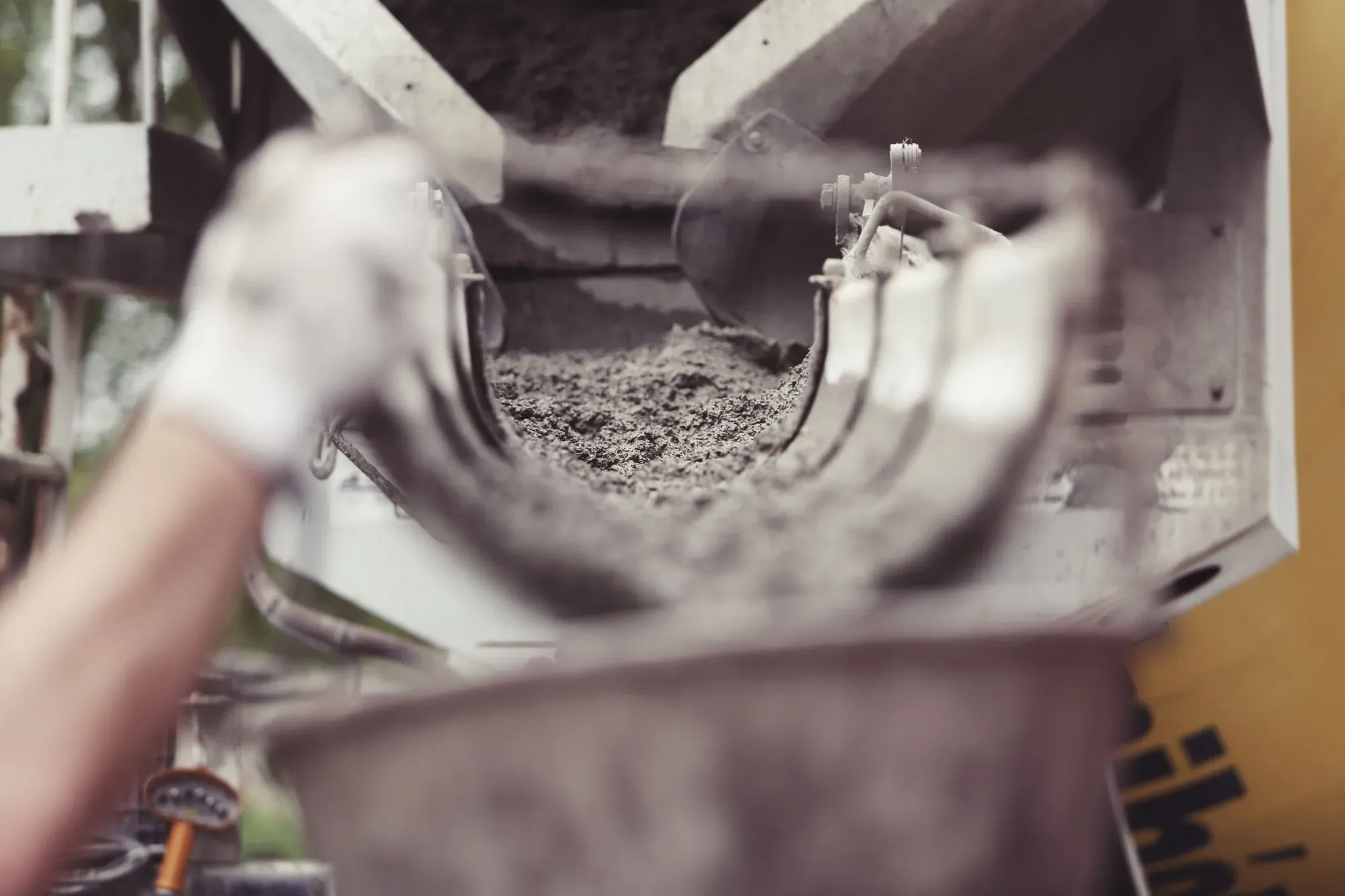 Wet concrete pouring from a mixer chute