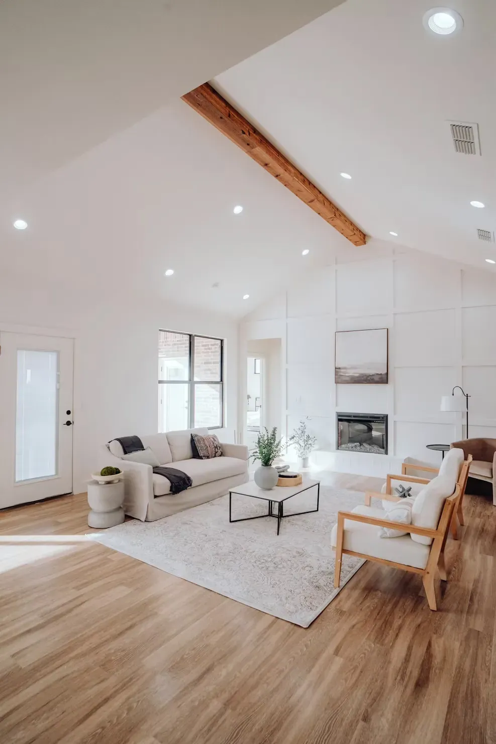 Living room with new wood flooring, a vaulted ceiling and a fireplace