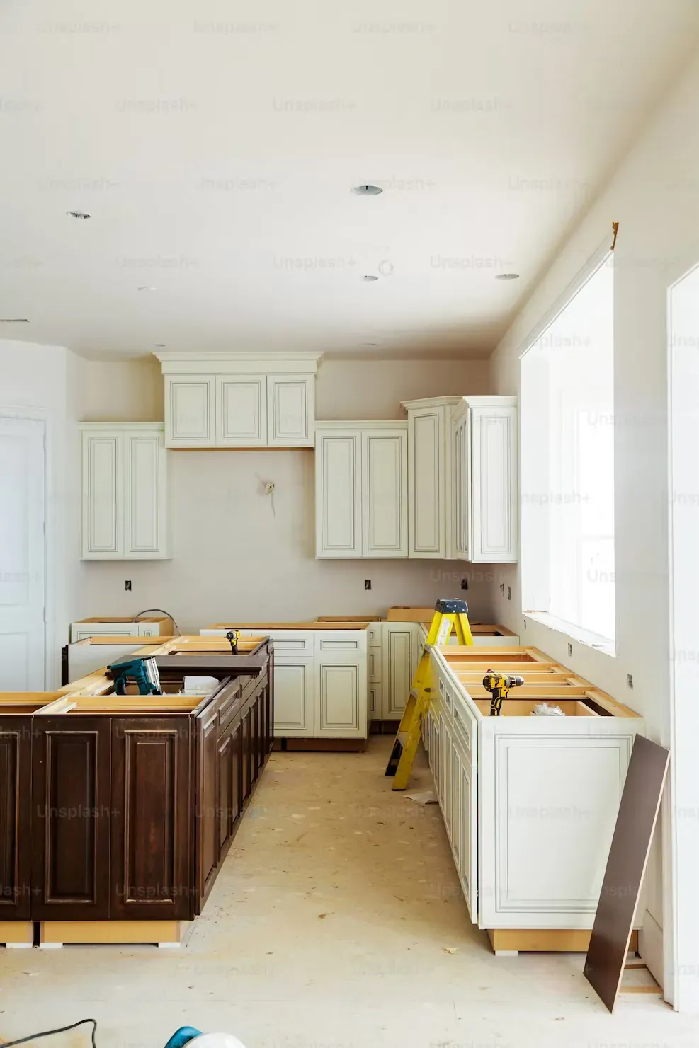 Kitchen mid-renovation with new cabinets being installed